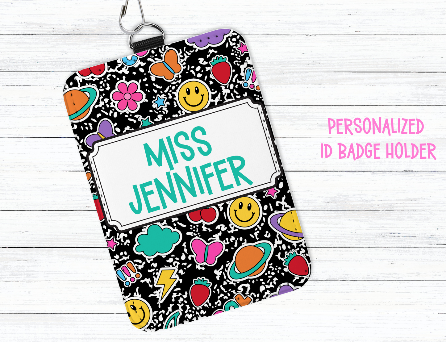 Personalized ID badge holder with colorful design and 'Miss Jennifer' text on a white wooden background