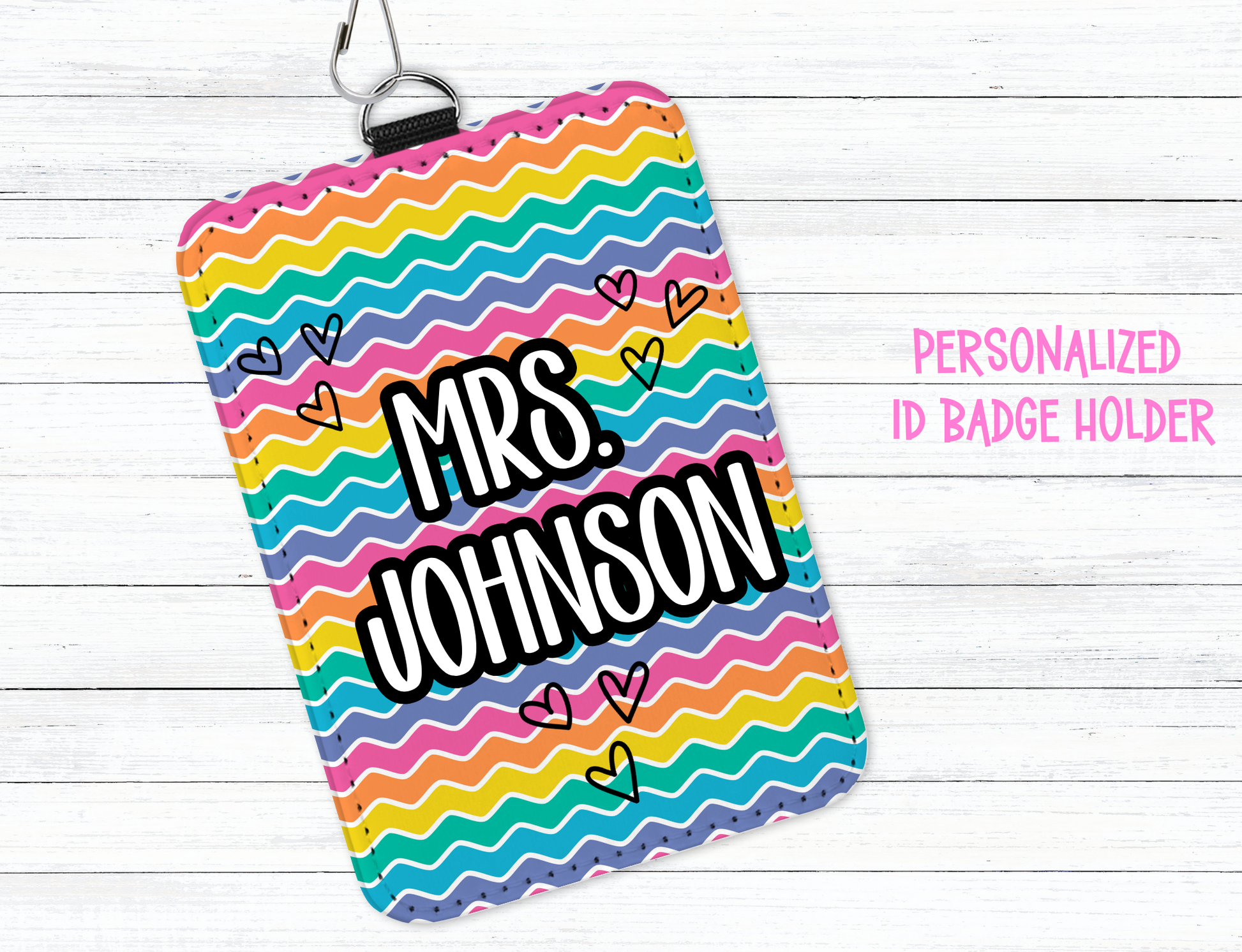 Colorful zigzag patterned ID badge holder with 'Mrs. Johnson' text on a white wooden background