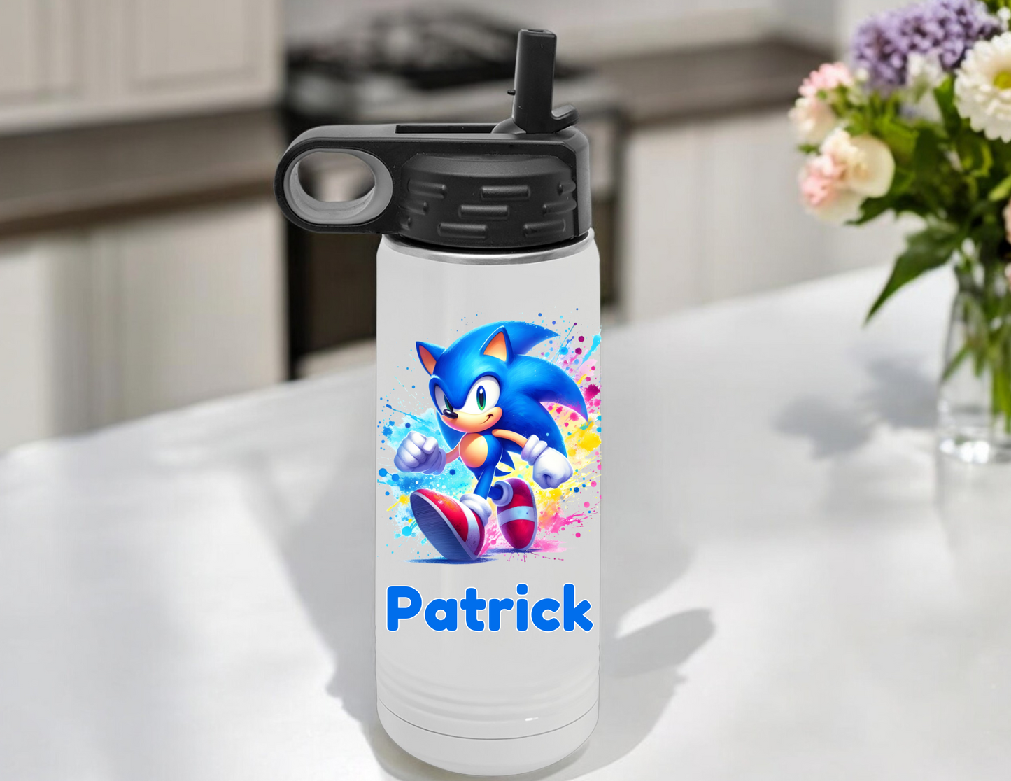 Water bottle with Sonic the Hedgehog design and 'Patrick' text on a table outdoors.